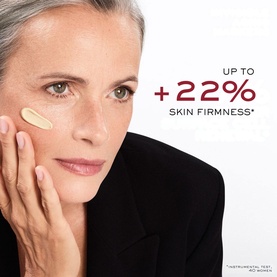 Model with Lanc&ocirc;me Absolue Longevity Reset Serum applied to cheek, text overlay showing up to +22% skin firmness