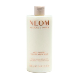 Neom Organics Real Luxury Creamy Body Wash in a large white pump bottle with coral and gold label detailing