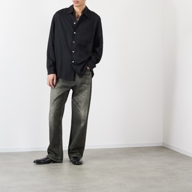 Model wearing Our Legacy Draping Black Lyocell casual shirt, styled with khaki straight-leg jeans and black leather boots.