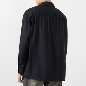 Model wearing Our Legacy casual shirt in Draping Black Lyocell, rear view showing relaxed fit, long sleeves and yoke detail.
