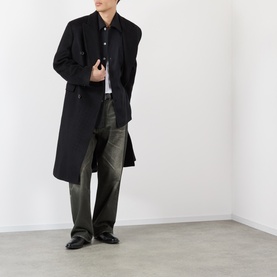 Model wearing Our Legacy Draping Black Lyocell shirt, styled with a black overcoat, olive wide-leg trousers and black leather shoes.