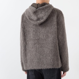 Model wearing Our Legacy Mole Grey Hairy Wool Zip Through hoodie, shown from behind, with textured fluffy knit fabric.