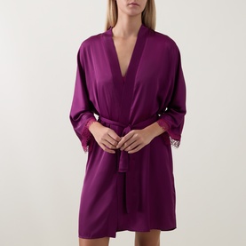 Model wearing Simone Perele Kimono in Blackberry, short wrap style with self-tie belt and delicate lace cuff trim.