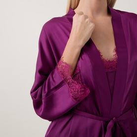 Model wearing Simone Perele Kimono in Blackberry, satin fabric with lace-trimmed cuffs, styled over matching lace camisole