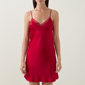 Model wearing Simone Perele Love Me Lace Chemise in Opera Red, featuring lace-trimmed V-neckline, thin straps and mini length silk finish.