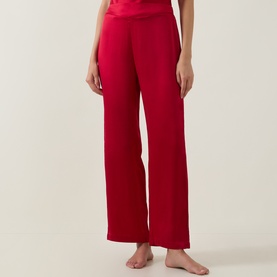 Model wearing Simone Perele PJ Pants in Opera Red, wide-leg silhouette in 100% silk with a fold-over waistband.