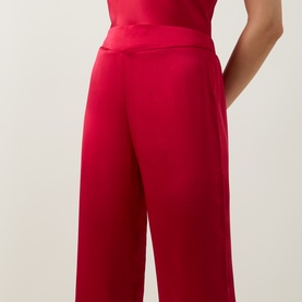 Model wearing Simone Perele Opera Red silk PJ pants, wide-leg cut with elasticated waistband, styled with matching red top.