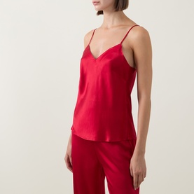 Model wearing Simone Perele Opera Red silk camisole top with V-neckline and thin straps, styled with matching red wide-leg trousers