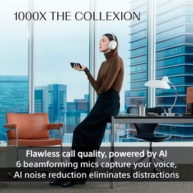 Model wearing Sony 1000X The Collexion white over-ear headphones, seated in modern office, styled with brown turtleneck and black trousers