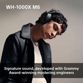 Model wearing Sony WH1000 Mark 6 Noise Cancelling Bluetooth Over Ear Headphones in cream, paired with a black leather jacket