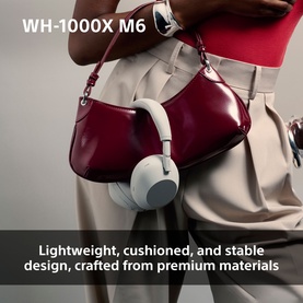 Sony WH1000 Mark 6 Noise Cancelling Bluetooth Headphones in cream, held by model alongside a burgundy shoulder bag