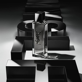 YSL Myslf Intense Eau de Toilette clear rectangular flacon with silver cap, displayed against dramatic black geometric shapes.