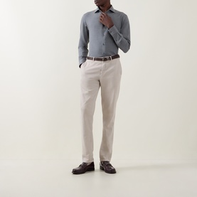 Model wearing Zegna grey cotton-cashmere casual shirt, styled with cream trousers and brown leather belt and loafers.