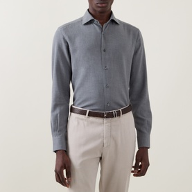 Model wearing Zegna grey cotton-cashmere casual shirt with spread collar, styled with beige trousers and brown leather belt.