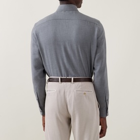 Model wearing Zegna grey cotton-cashmere casual shirt, back view, styled with beige trousers and brown belt.