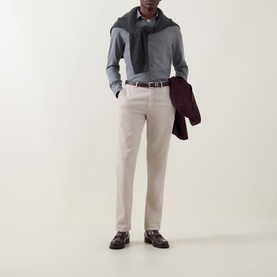 Model wearing Zegna grey cotton-cashmere casual shirt, styled with stone chinos, grey scarf, and burgundy jacket draped over arm.