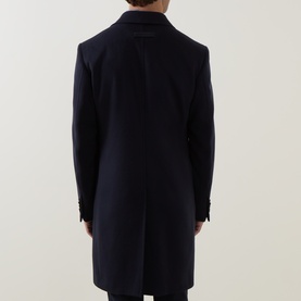 Model wearing Zegna navy blue wool cashmere coat, rear view showing clean single-vent back and slim tailored silhouette.
