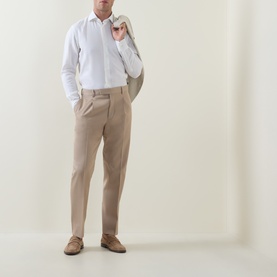 Model wearing Zegna Formal Slim-Leg Trousers in light taupe with front pleats and pressed creases, styled with white shirt and beige blazer.