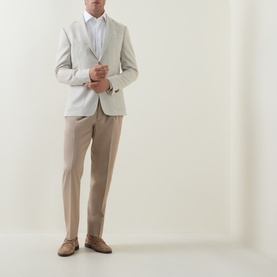 Model wearing Zegna Formal Slim-Leg Trousers in Light Taupe, styled with a light grey blazer, white shirt and tan suede loafers.