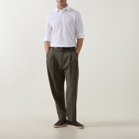 Model wearing Zegna white cotton polo shirt with olive tailored trousers and brown loafers