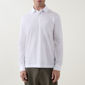 Model wearing Zegna white cotton long-sleeve polo shirt, styled with khaki trousers