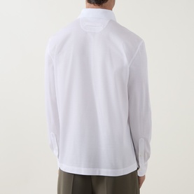 Model wearing Zegna white cotton long-sleeve polo shirt, back view, styled with khaki trousers.