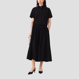Model wearing Maje red short-sleeve midi shirt dress with button-front bodice and full skirt, styled with black heels