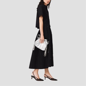 Model wearing Maje red midi dress with button detail, styled with silver clutch bag and black slingback heels