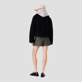 Model wearing Maje red Womens French Dress, styled with black textured jacket, bucket hat, and loafers, shot from behind