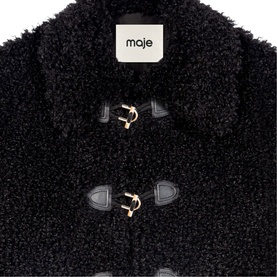 Maje black curly teddy fleece duffle coat with gold-tone toggle fastenings and leather loop detail, close-up shot.