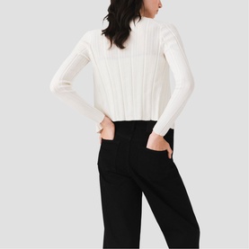 Model wearing Maje metallic ribbed cropped roll-neck jumper with long sleeves, styled with black wide-leg trousers