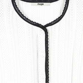 Maje white open-knit top with black scalloped trim detailing along neckline and front placket, close-up detail shot.