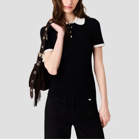 Model wearing Maje red short-sleeve polo top with white collar and gold button detail, styled with brown suede fringed bag