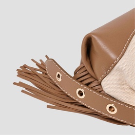 Maje bag in black with fringe detail, gold-tone eyelets, and canvas and leather panels. Close-up shot.