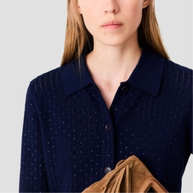 Model wearing Maje navy blue embellished shirt with subtle crystal dot detailing, styled with a tan suede skirt or bag.