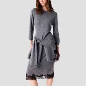 Model wearing Maje Womens French Dress in grey knit with tie-front detail and black lace hem trim