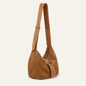 Bash Dump bag in brown suede with gold-tone clasp, single adjustable shoulder strap, and relaxed slouchy silhouette