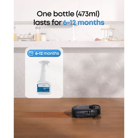 Eufy Fabric Cleaner 473ml spray bottle beside a robot vacuum, with text stating one bottle lasts 6&ndash;12 months