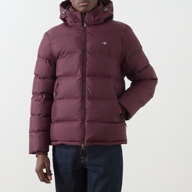 Model wearing Gant Darkened Wine puffer jacket with hood, styled with dark denim jeans
