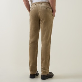 Model wearing Gant light taupe cotton chino trousers, rear view, styled with black leather shoes.