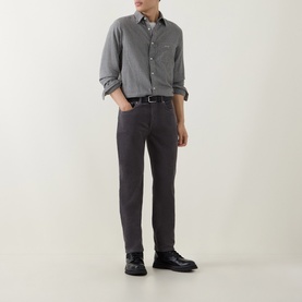 Model wearing Gant Dusky Anthracite cord jeans with a grey shirt, black belt and black lace-up shoes.