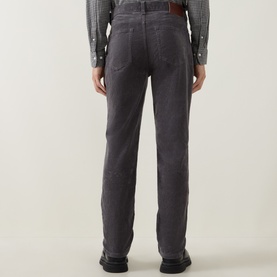 Model wearing Gant Dusky Anthracite cord jeans, rear view, styled with a check shirt and brown belt, black shoes.
