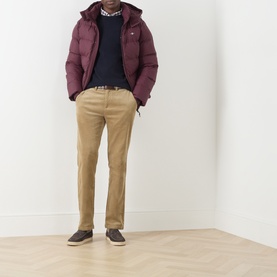 Model wearing Gant Navy Wool Crew Neck jumper, styled with burgundy puffer jacket, tan chinos and dark trainers.