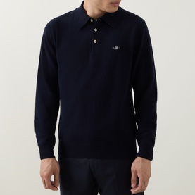 Model wearing Gant Shield Logo Fine-Knit Polo Sweater in navy, featuring long sleeves, three-button placket and chest logo embroidery.
