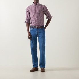 Model wearing Gant Deep Grape Wine striped cotton reg shirt, styled with mid-blue jeans, brown belt and suede shoes.