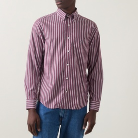 Model wearing Gant Reg Shirt in deep grape wine stripe, styled with blue jeans. Long sleeve, button-down collar, chest pocket.