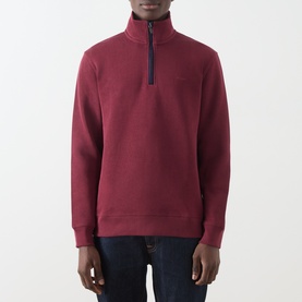 Model wearing Gant Deep Grape Wine cotton quarter-zip sweatshirt with navy zip detail, styled with dark jeans