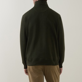 Model wearing Gant dark moss green cotton half-zip sweatshirt, back view, styled with tan trousers.