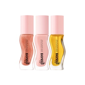 Gisou lip oil set of three, featuring pink-toned and golden-yellow shades in curved glass bottles with pink caps