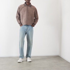 Model wearing JW Anderson Mouse Grey suede casual jacket, styled with light-wash straight-leg jeans and white trainers.